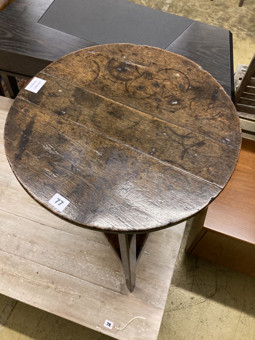 A small 18th century oak cricket table, with understage, 48cm diameter, height 70cm